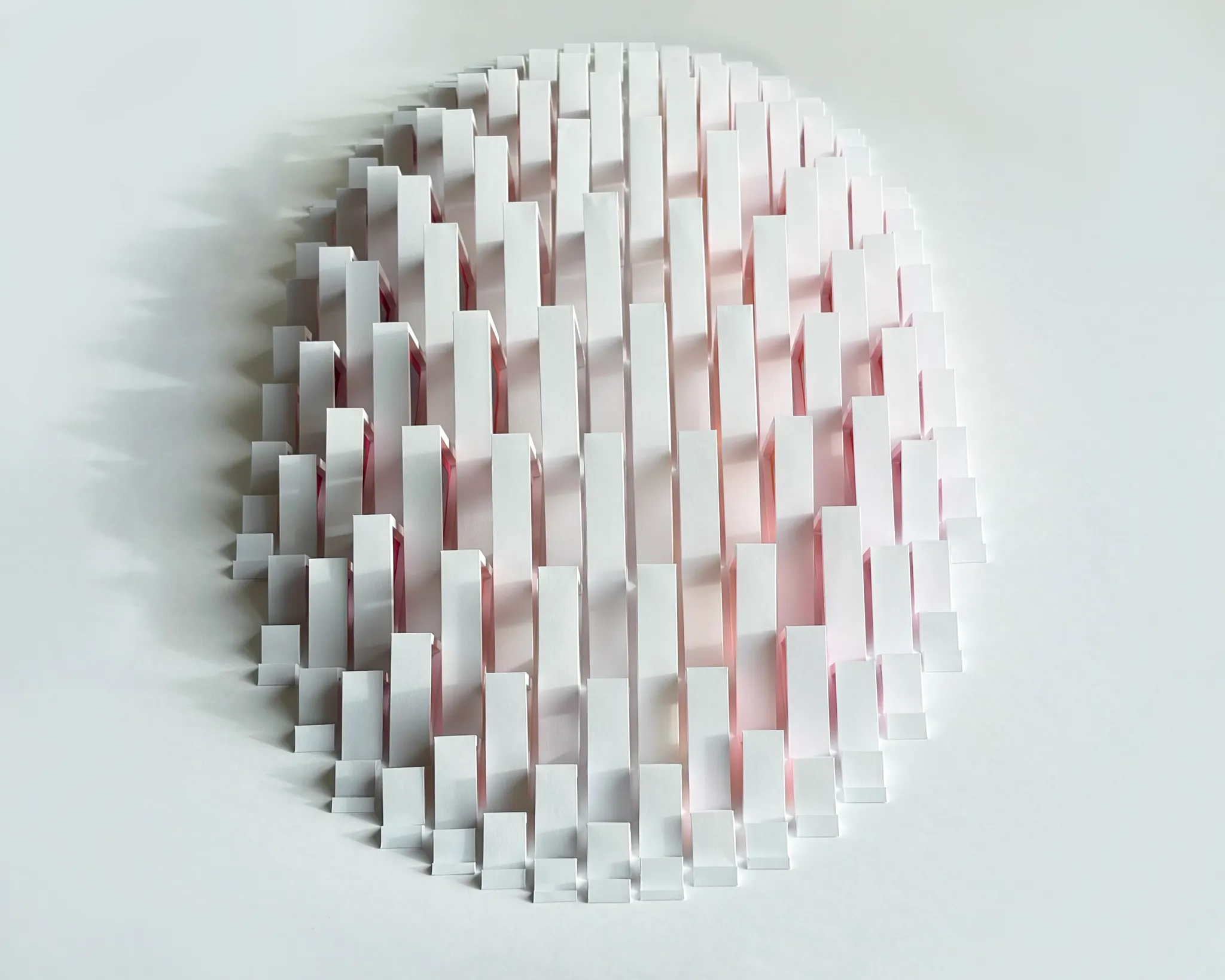 No. 24 – Triangula – The work from the front in soft side light, pink shimmering between the white strips