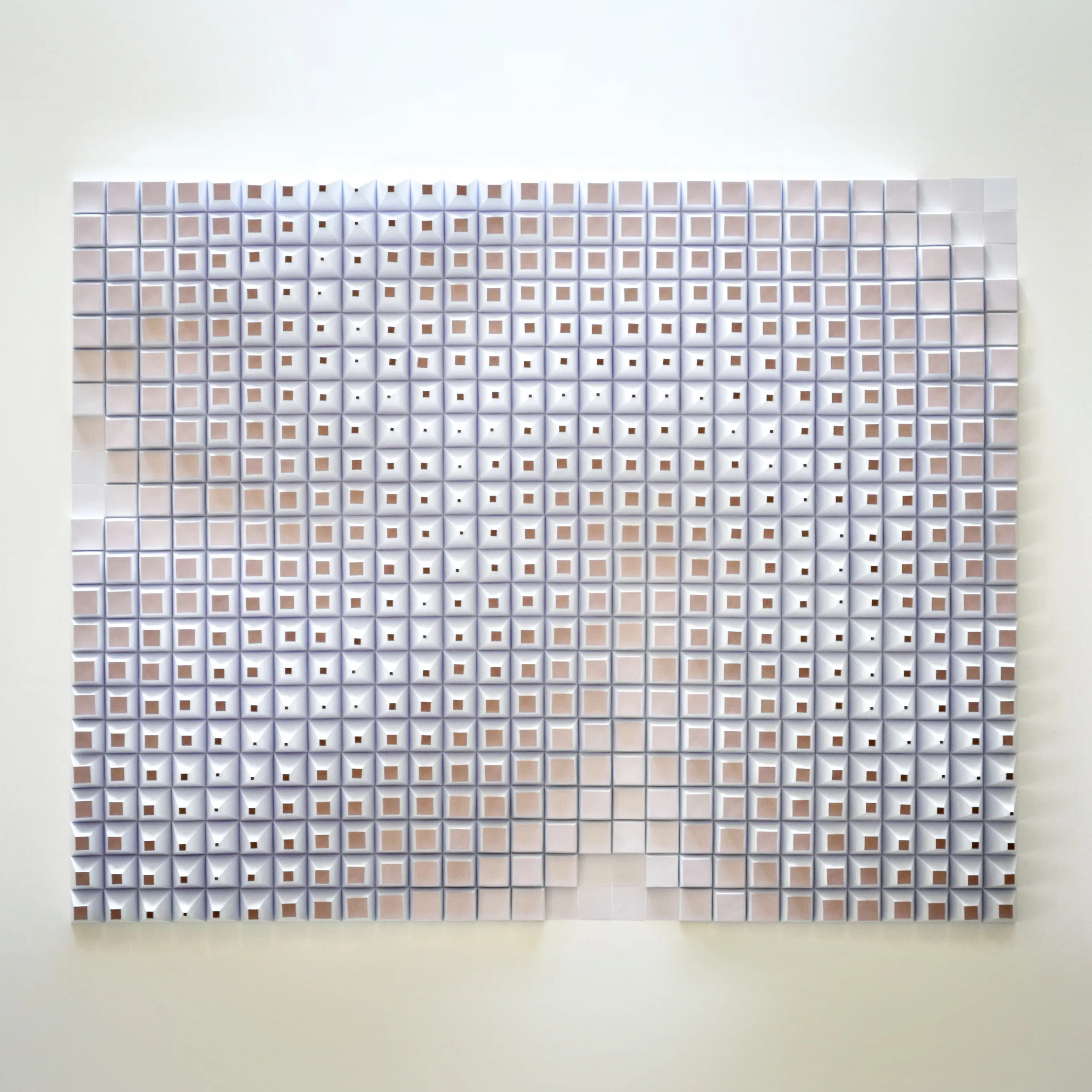 The whole work head-on, a dense grid of white truncated pyramids with three spiral arms running through it