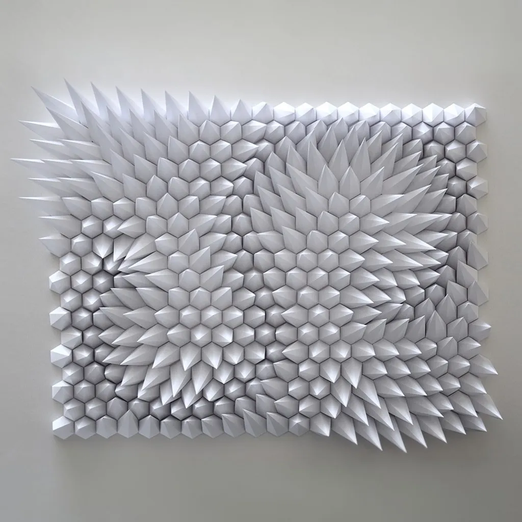The whole white relief head-on, a wave of pyramid tips running across the surface