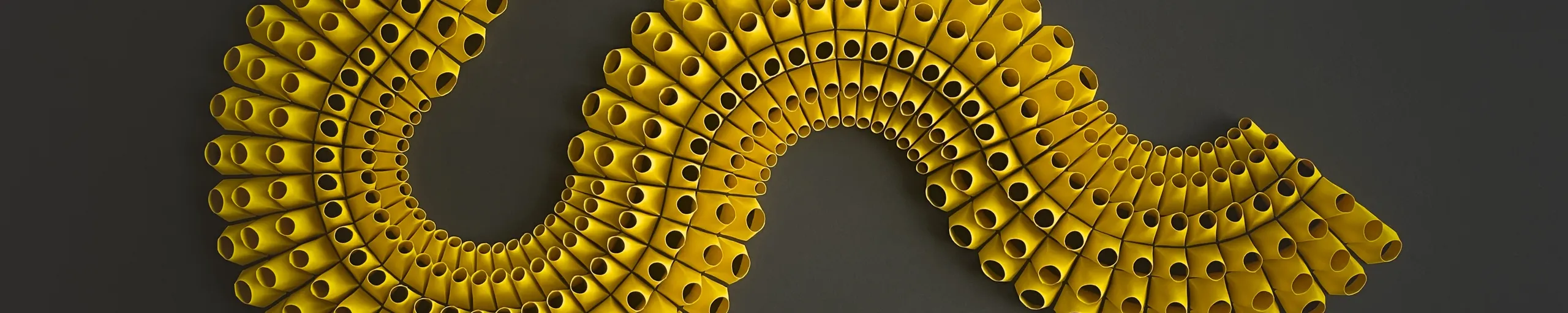 The yellow strand winding from left to right through the frame and breaking off at the edge