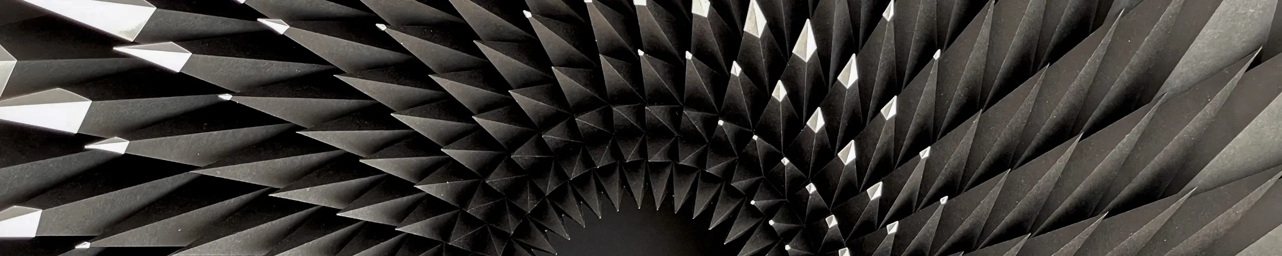 Curved rows of black spikes running in from the edges towards the dark funnel