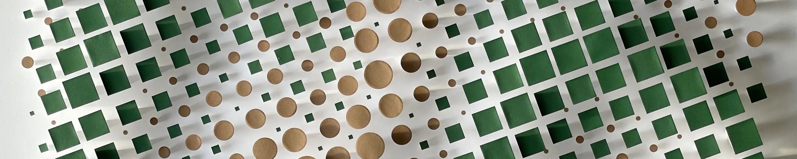 The grid from above at an angle, green squares at the edges and a field of brown circles at the centre