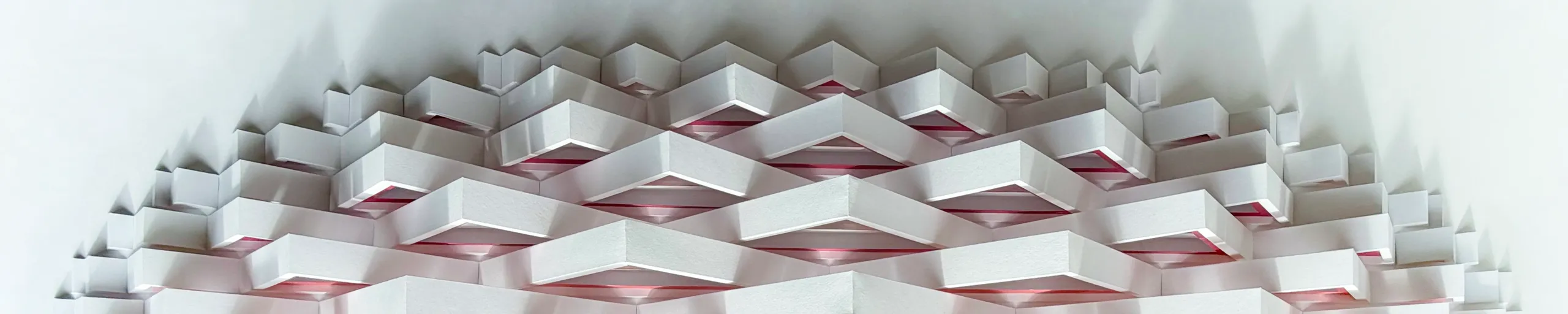 The upper curve of the oval, rows of white chevrons stepping up to the rounded edge, pink shimmering under every edge