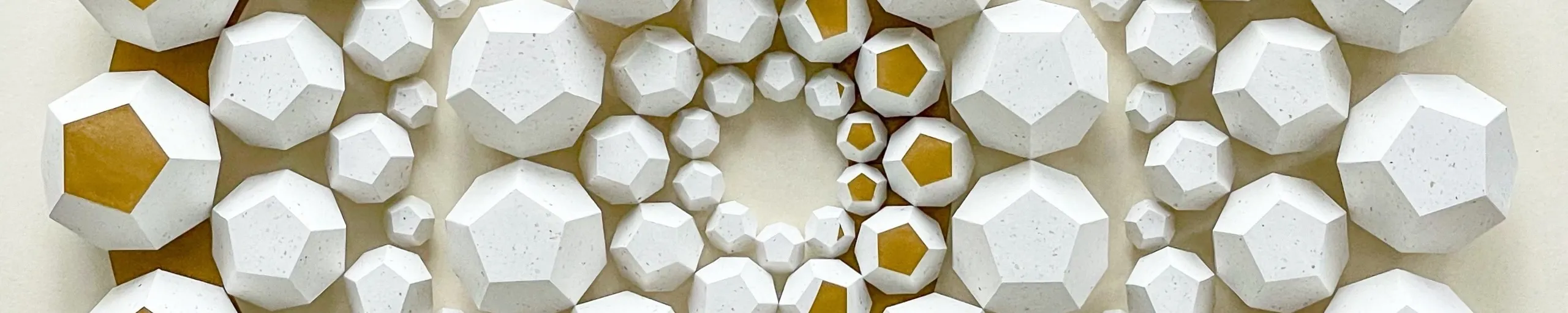 Gold lying in the depth between the white bodies, openly visible on one large facet at the left